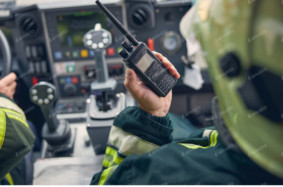 Firefighter using a radio inside the cab of a fire apparatus